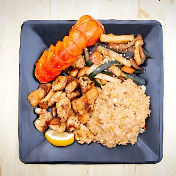 Hibachi Bus Stop's hibachi plate with lobster, chicken, fried rice, and vegetables.