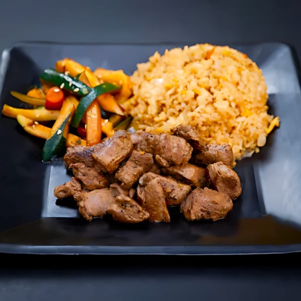 Hibachi Bus Stop's hibachi steak, fried rice, and mixed vegetables on a black plate.